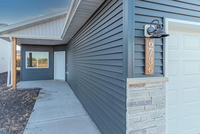 view of exterior entry with a garage