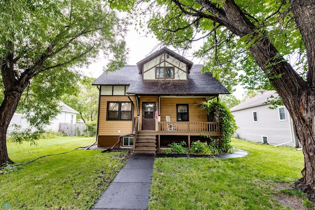 view of front of home featuring a front yard and covered porch