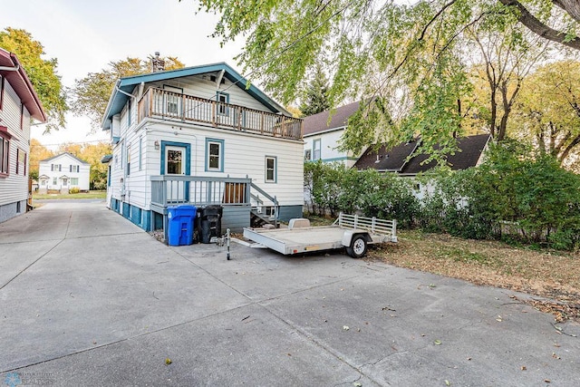 rear view of property featuring a balcony