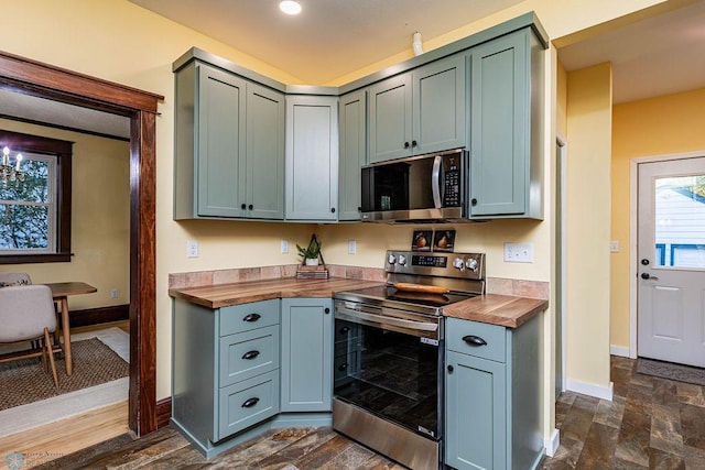 kitchen featuring appliances with stainless steel finishes and butcher block counters