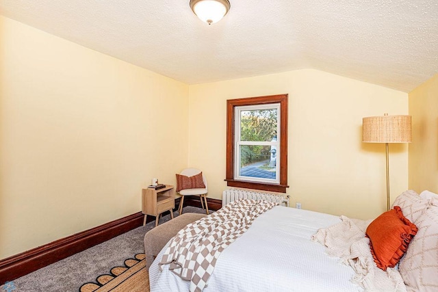 carpeted bedroom featuring a textured ceiling, lofted ceiling, and radiator heating unit