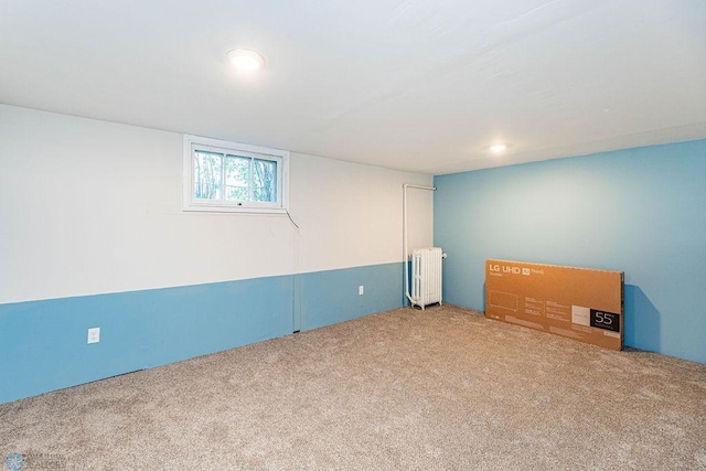 basement featuring carpet floors and radiator heating unit