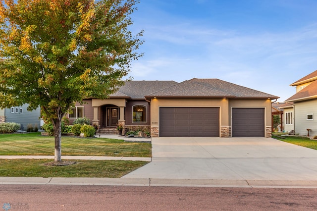 view of front of property with a garage and a front lawn