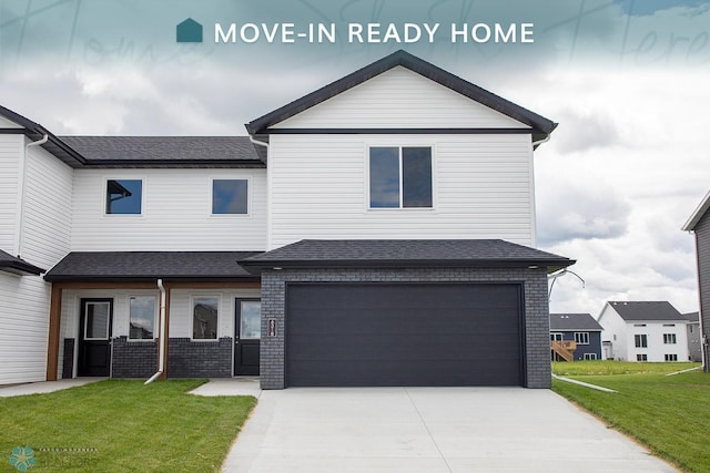 view of front of property featuring a garage and a front yard