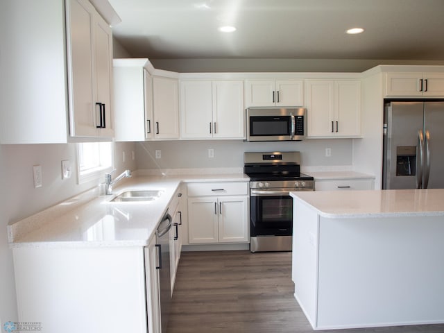 kitchen featuring light stone counters, white cabinets, sink, stainless steel appliances, and dark hardwood / wood-style flooring