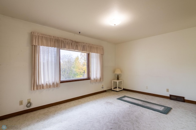 unfurnished room featuring carpet