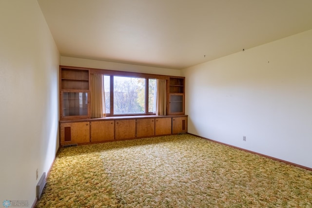 unfurnished room featuring light colored carpet