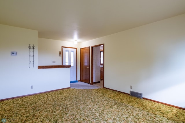 unfurnished room with light colored carpet