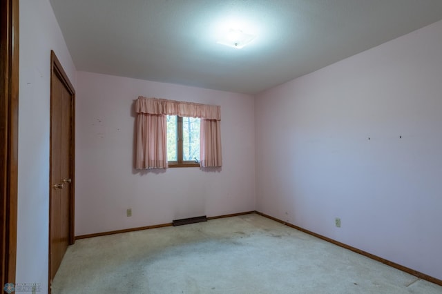 unfurnished room featuring light colored carpet