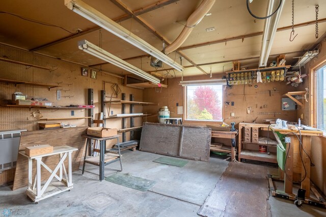 miscellaneous room featuring a workshop area and concrete floors