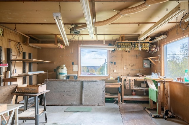 misc room with a workshop area, concrete floors, and plenty of natural light