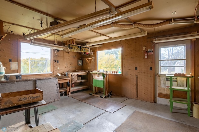 misc room featuring a workshop area and concrete floors