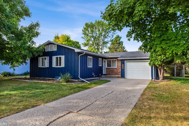 single story home featuring a garage and a front lawn