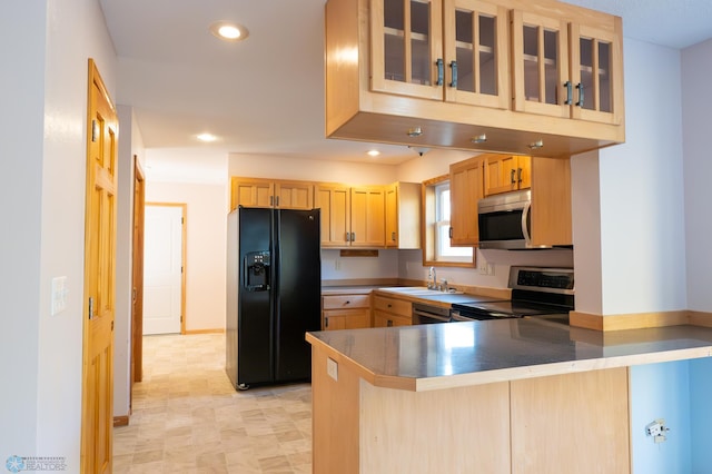 kitchen with light brown cabinets, sink, stainless steel appliances, and kitchen peninsula