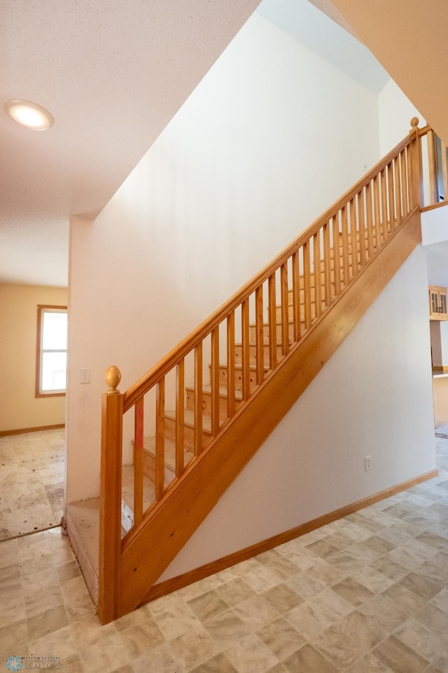 stairs featuring vaulted ceiling