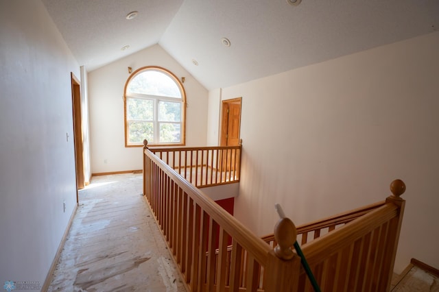 hallway featuring vaulted ceiling