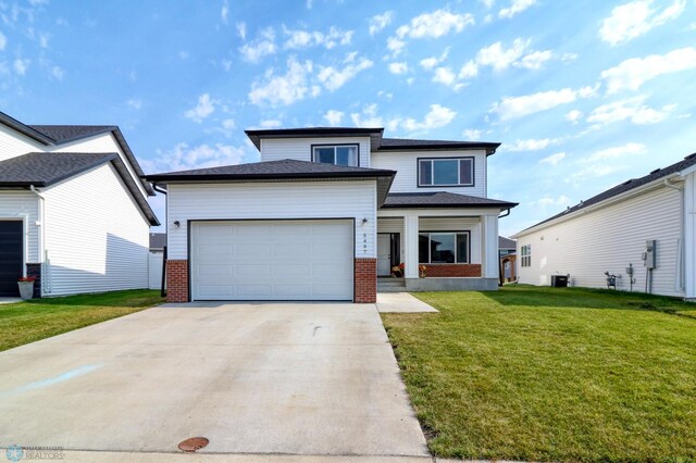 view of front of home with a garage and a front lawn