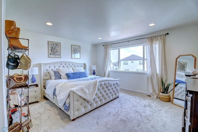 bedroom featuring light carpet