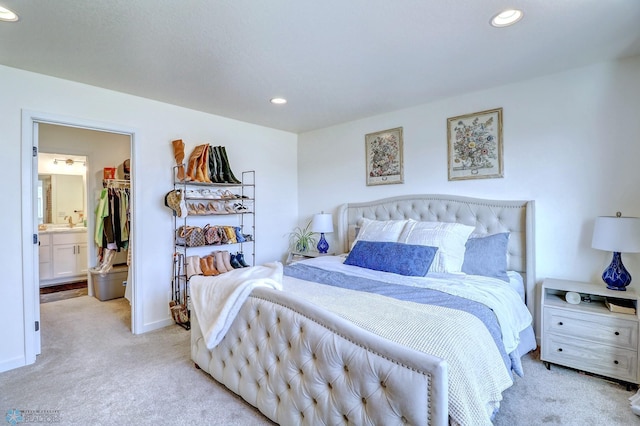 carpeted bedroom featuring a closet, connected bathroom, and a spacious closet