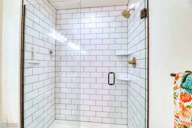 bathroom with a shower with shower door