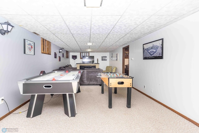 playroom with carpet floors and a drop ceiling