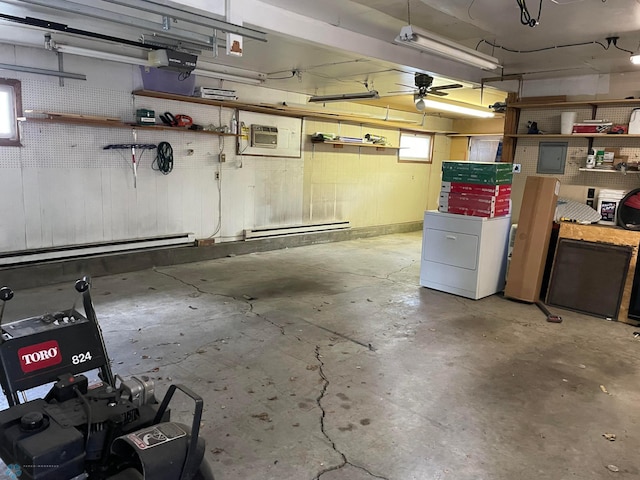 garage featuring washer / clothes dryer, a wall mounted AC, a baseboard heating unit, and ceiling fan