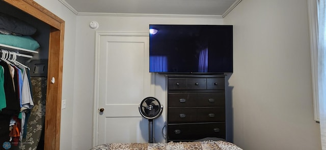 bedroom with a closet and crown molding