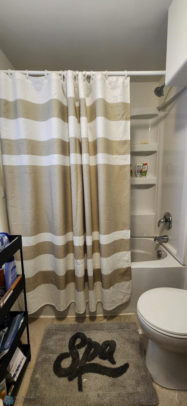 bathroom featuring tile patterned floors, shower / bath combo, and toilet