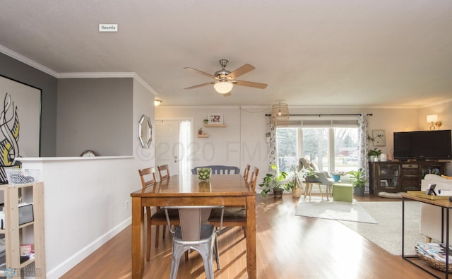 dining area featuring ornamental molding, hardwood / wood-style flooring, and ceiling fan