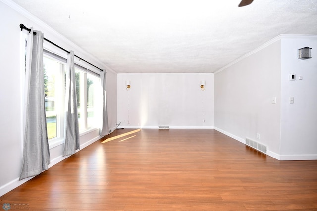 unfurnished room featuring ornamental molding, hardwood / wood-style flooring, and a textured ceiling