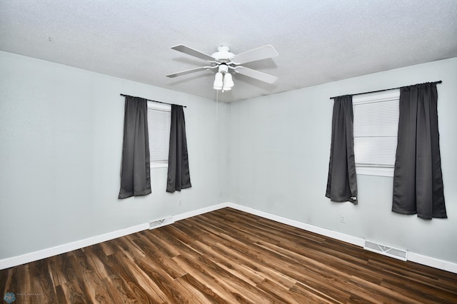 unfurnished room with dark wood-type flooring, a textured ceiling, and ceiling fan