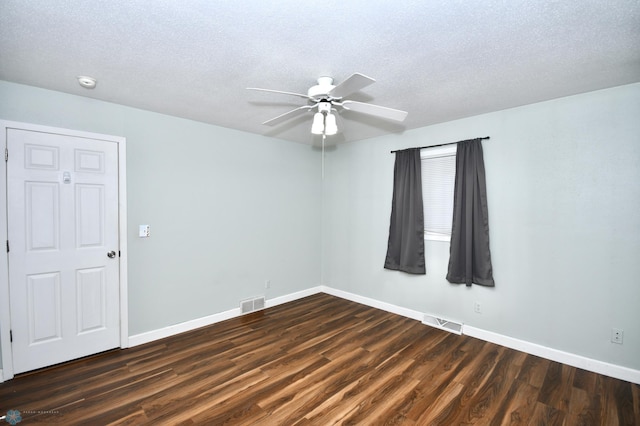 unfurnished room featuring ceiling fan, a textured ceiling, and dark wood-type flooring