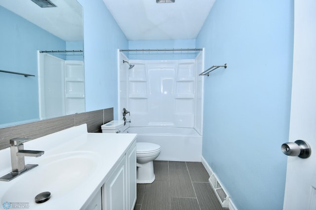 full bathroom featuring tub / shower combination, vanity, and toilet