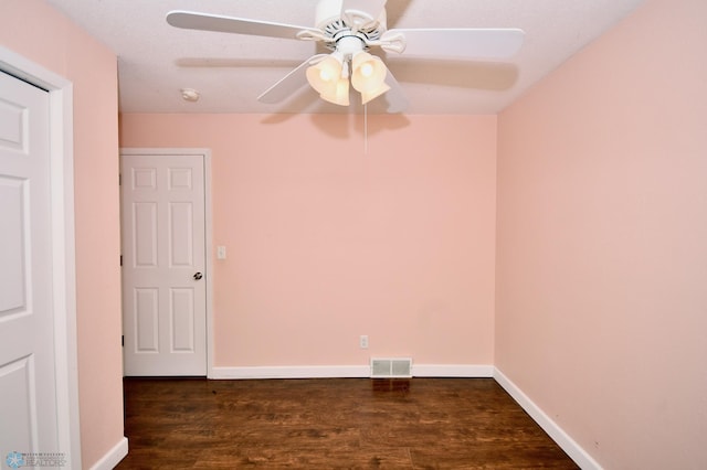 spare room with dark hardwood / wood-style floors and ceiling fan