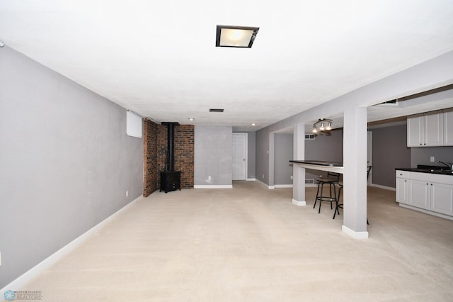 unfurnished living room with light carpet and sink