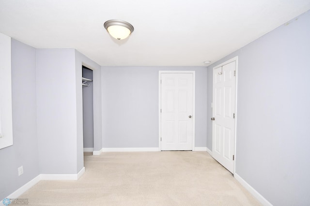 unfurnished bedroom featuring light carpet