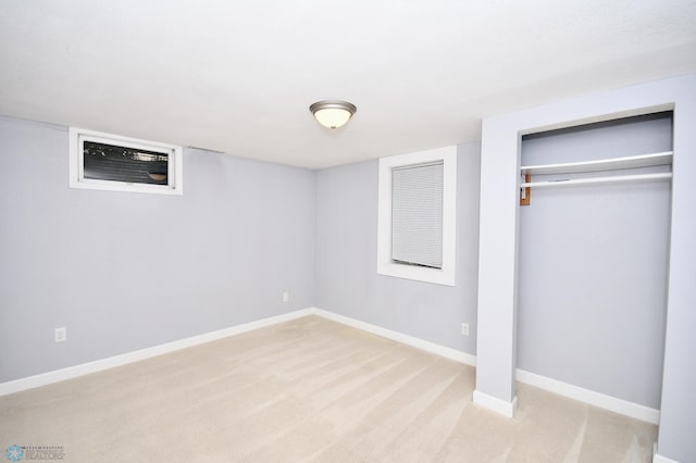 unfurnished bedroom featuring light colored carpet and a closet