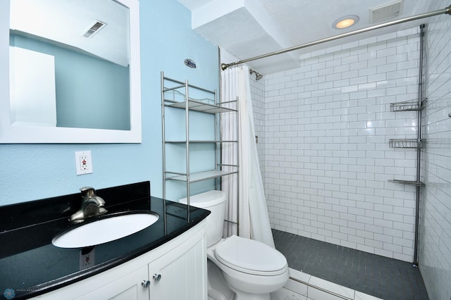 bathroom featuring vanity, tile patterned floors, toilet, and curtained shower