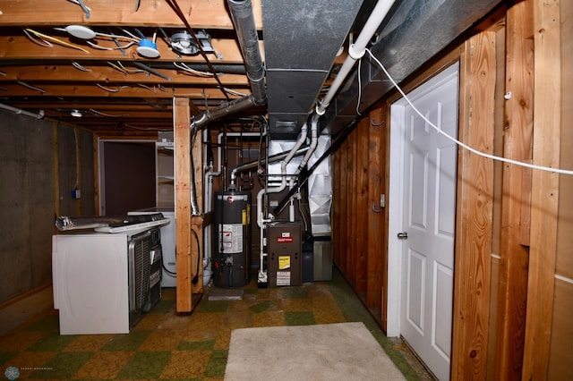 basement with gas water heater, wood walls, washer / clothes dryer, and heating unit