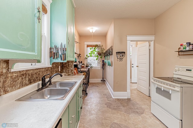 kitchen featuring white electric range, green cabinets, sink, and a textured ceiling