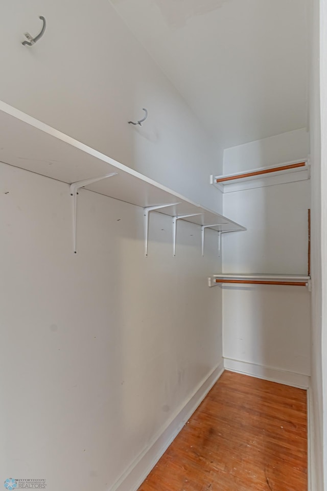 spacious closet featuring hardwood / wood-style floors