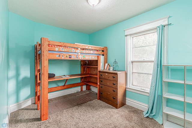 carpeted bedroom with a textured ceiling