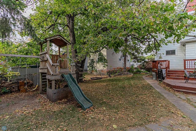 view of yard with a playground and a deck