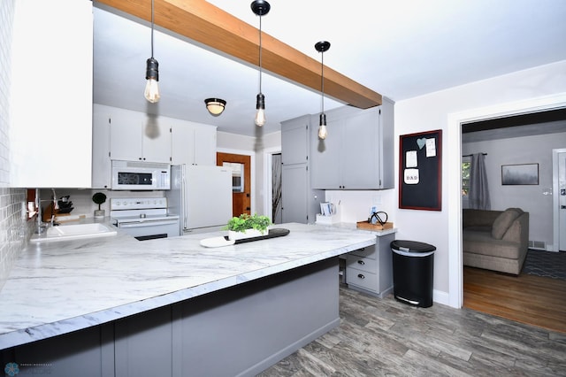 kitchen featuring white appliances, gray cabinets, decorative light fixtures, and dark hardwood / wood-style flooring