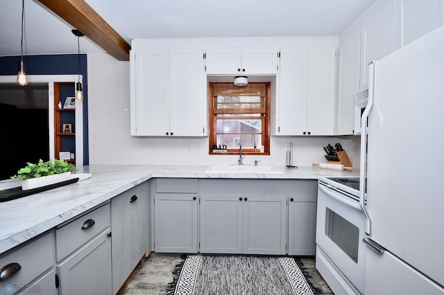 kitchen with pendant lighting, gray cabinets, white appliances, and sink