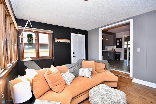 living room with hardwood / wood-style flooring and a textured ceiling