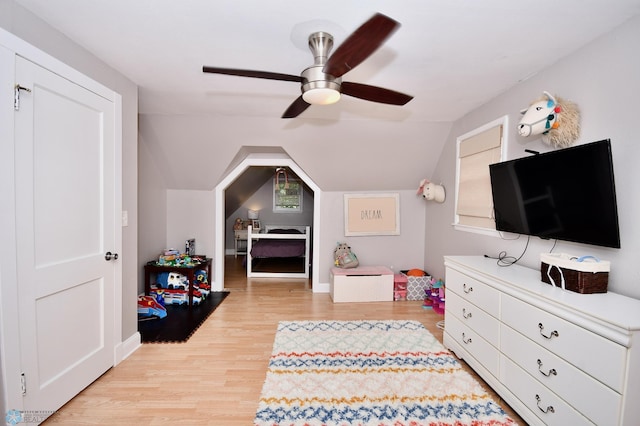 playroom with vaulted ceiling, light wood-type flooring, and ceiling fan