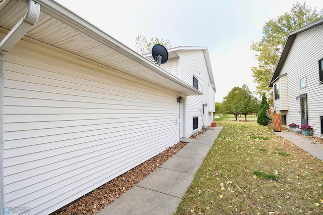 view of side of home with a yard