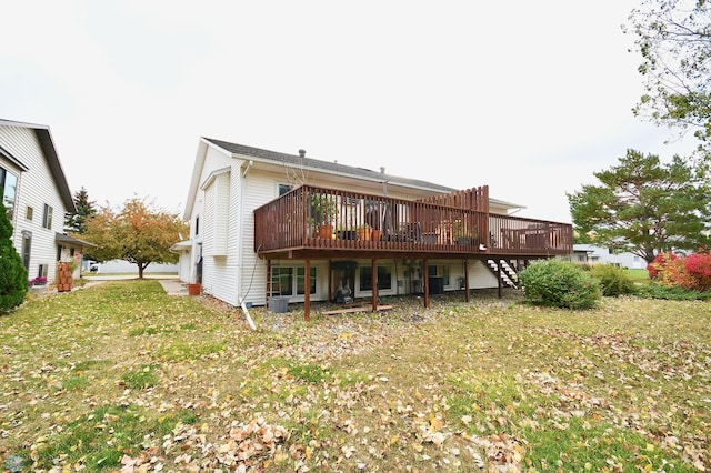 back of property featuring a deck and a yard