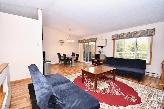 living room featuring wood-type flooring, a textured ceiling, baseboard heating, and vaulted ceiling